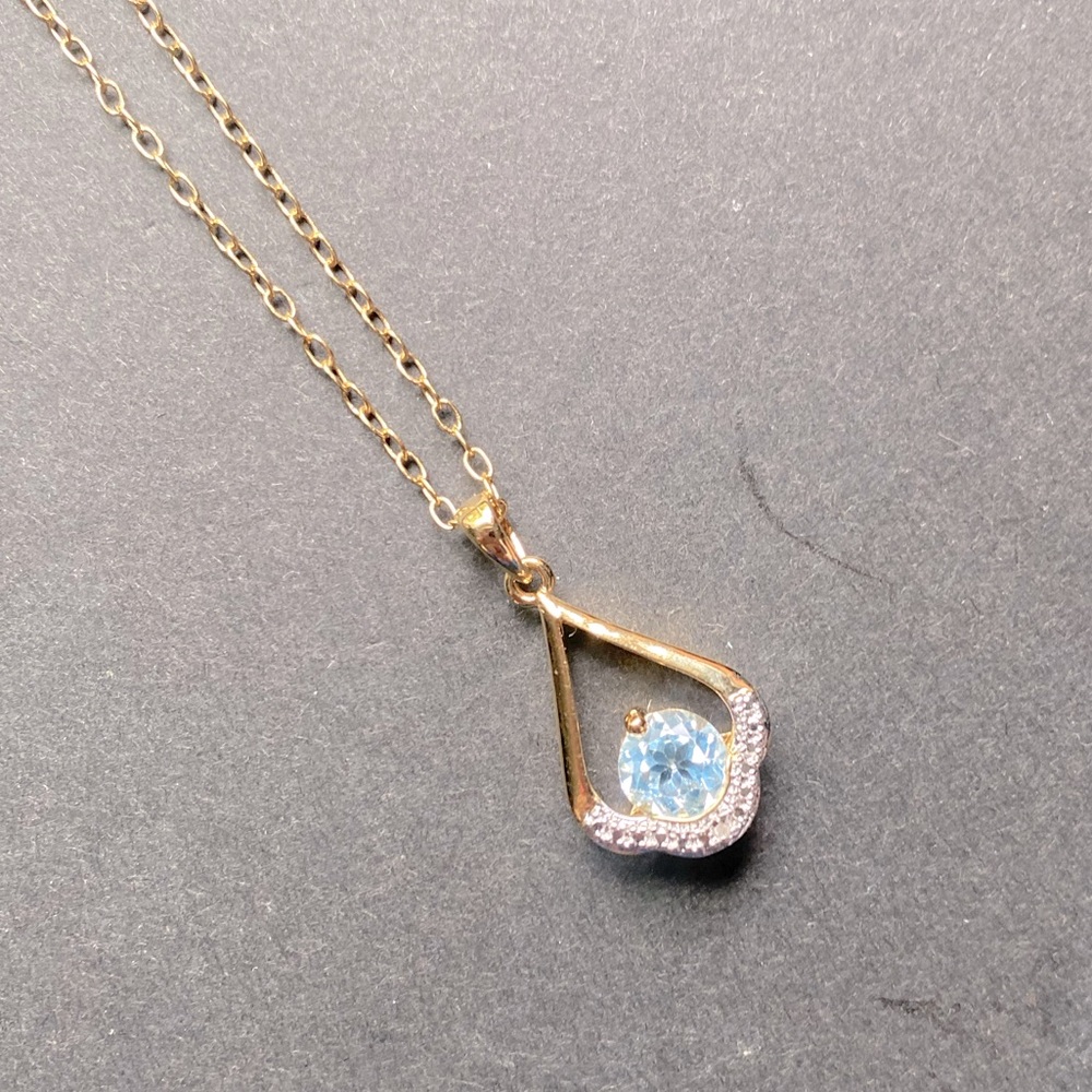 PAJ gold toned necklace with blue topaz pendant